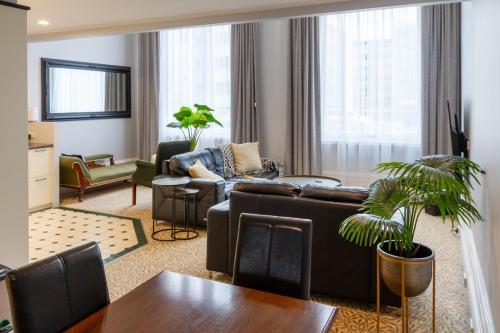 a living room with a couch and a table at Cathedral Square Apartment 2 bed in Christchurch