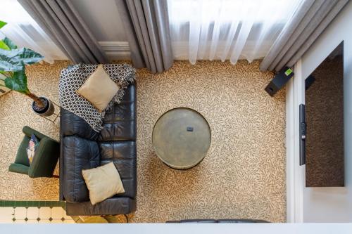 a living room with a couch and a mirror at Cathedral Square Apartment 2 bed in Christchurch