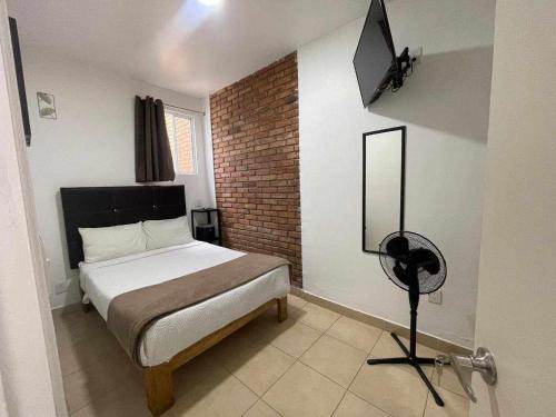 a bedroom with a bed and a television in it at Aldama in Morelia