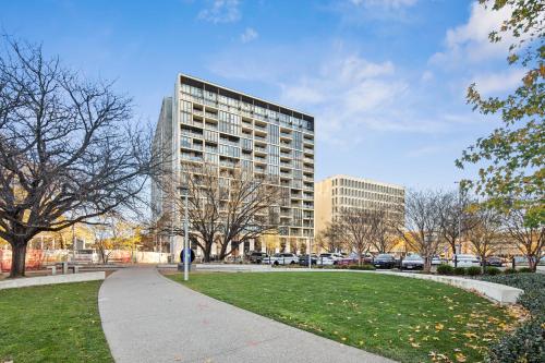 a tall building with a park in front of it at Patio Mt view 1BR apt in CBD near ANU and museum with free parking and WiFi in Canberra