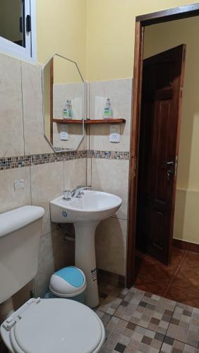 a bathroom with a sink and a toilet and a mirror at El MasSi in Tilcara