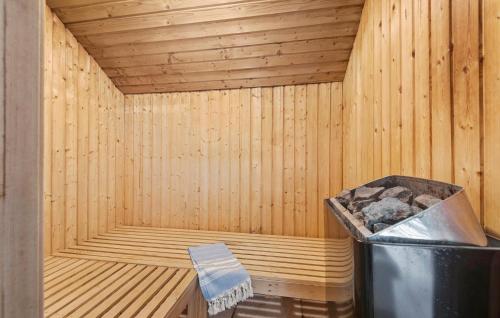 a wooden sauna with a trash can in it at 4 Bedroom Pet Friendly Home In Blåvand in Ho