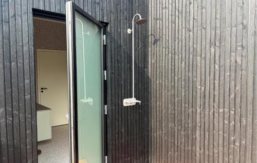 a shower with a glass door next to a wall at 5 Bedroom Lovely Home In Lemvig in Lemvig