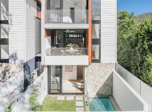 an apartment building with a balcony and a swimming pool at Urbanstayz - Lakehouse No 4- Luxury Lakefront Getaway Villa Pet Friendly in Cabarita Beach