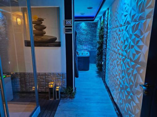 a walkway in a building with blue lights at Glamour Wellness Apartments in Zagreb