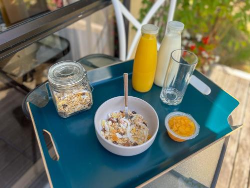 a blue table with a bowl of cereal and milk at Swan House in Martinborough 