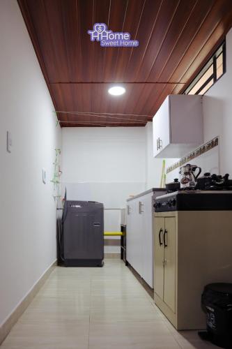 a kitchen with a black appliance in a room at Home Sweet Home in Pitalito
