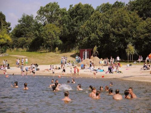 a group of people in the water at a beach at Villa in France with Private Pool in Vasles