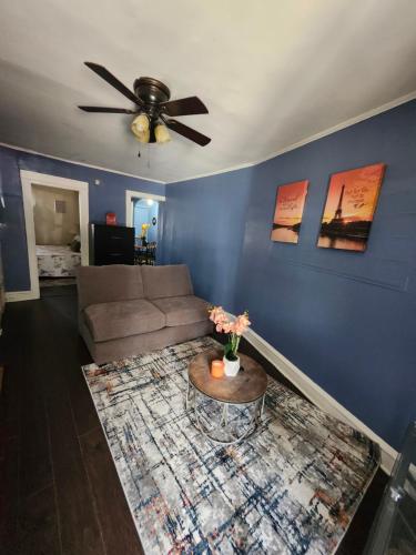 a living room with a couch and a ceiling fan at The Spot in Stonehurst