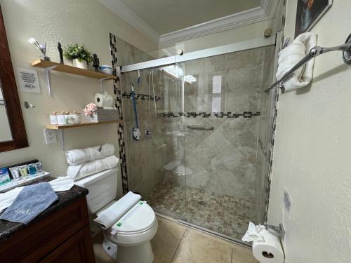 a bathroom with a shower and a toilet at Sunshine Nest in Lehigh Acres