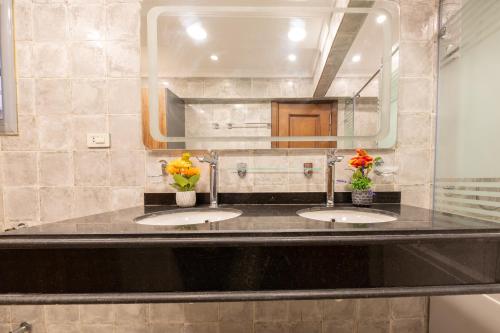 a bathroom with two sinks and a large mirror at Royal Heliopolis in Cairo