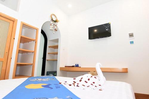 a bedroom with a bed with a towel on it at Sea Night - Sea Home Hotel in Phan Thiet