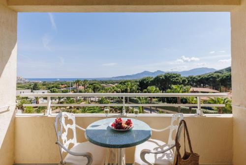 a table and chairs on a balcony with a view at Hotel Corsica & Spa Serena in Calvi