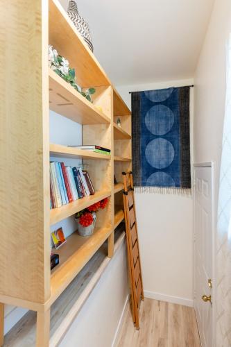 a room with wooden shelves and a ladder at Quiet City Retreat Near Light Rail, Downtown & Stadiums! in Seattle
