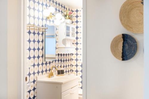 a bathroom with a sink and a mirror at Quiet City Retreat Near Light Rail, Downtown & Stadiums! in Seattle