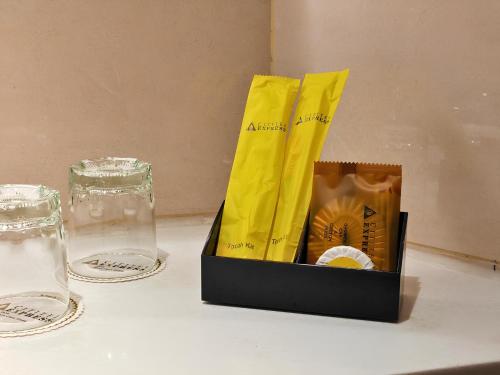a box on a table with two glasses on it at Cititel Express Ipoh in Ipoh