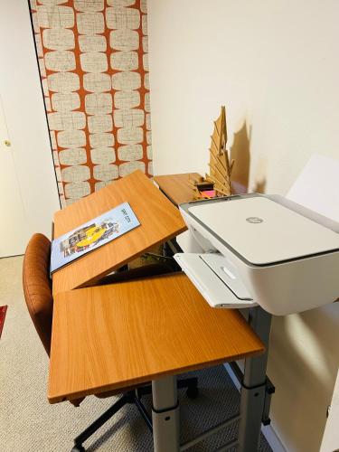a desk with a laptop computer on top of it at Quiet City Retreat Near Light Rail, Downtown & Stadiums! in Seattle