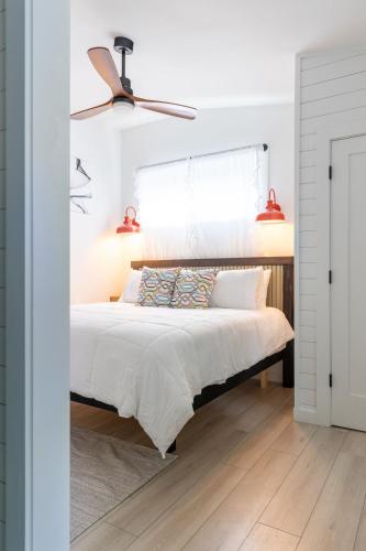 a bedroom with a bed and a ceiling fan at Tranquility Pond Cottage, Relax, Fish and Unwind in Buford