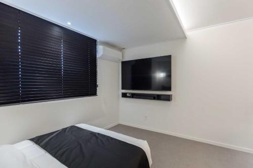a bedroom with a bed and a flat screen tv at Aank Hotel and Spa Daejeon Yuseong in Daejeon
