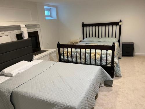 a bedroom with two twin beds and a fireplace at basement Two queen beds with private bathroom in Lexington in Lexington