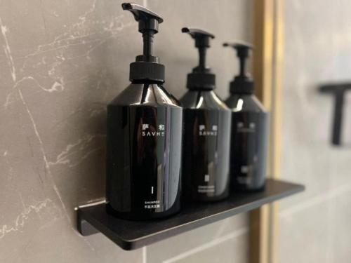 a group of three bottles of soap sitting on a shelf at Atour Light Hotel Beijing Guang'anmen in Beijing