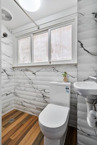 a bathroom with a toilet and a sink at Millers on Kent III - Perfect Abode for 10 people in Sydney