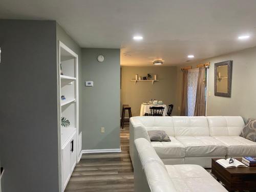 a living room with a white couch and a table at The Big Beautiful Townhouse in Frederick
