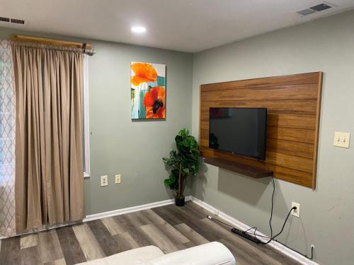 a living room with a flat screen tv on a wall at The Big Beautiful Townhouse in Frederick