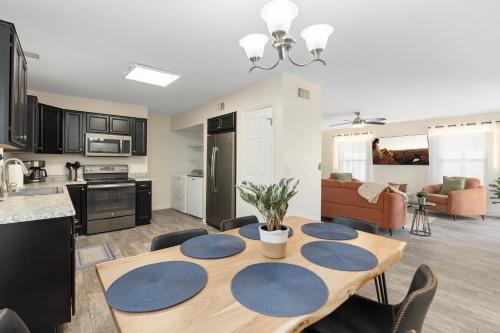 a kitchen and living room with a table and chairs at Button Bungalow Spring Fun & Golfing Hot Tub BBQ in Mesa