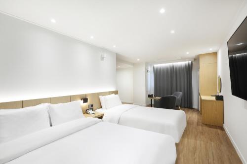Ένα ή περισσότερα κρεβάτια σε δωμάτιο στο BrownDot Hotel Hongseong Naepo