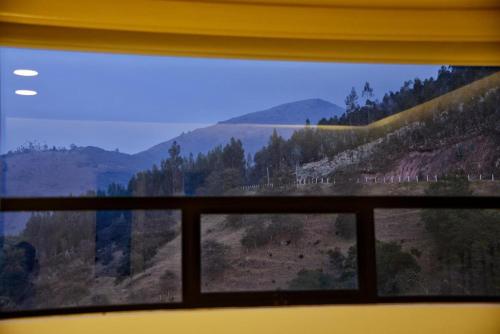 a view of a mountain view from a window at El Encanto - La Trinidad, cabaña con jacuzzi in Duitama