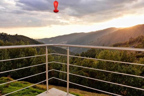 a hot air balloon flying over a mountain valley at El Encanto - La Trinidad, cabaña con jacuzzi in Duitama
