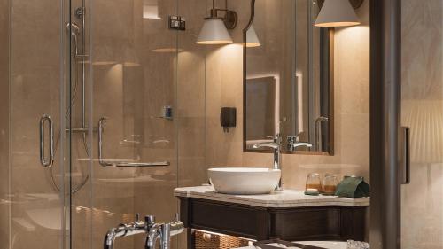 a bathroom with a sink and a shower at Golden Sun Hotel - Dalat in Da Lat