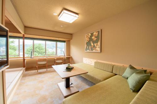 a living room with a couch and a table at Fuji Lake Hotel in Fujikawaguchiko
