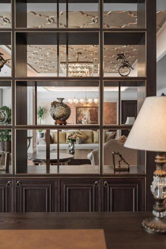 a large glass cabinet with vases on it at Golden Sun Hotel - Dalat in Da Lat