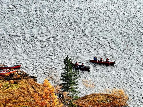 a group of people in boats on the water at 8 person holiday home in ÅSERAL in Hamkoll