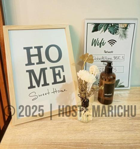 a sign and a bottle of wine on a table at AVIDA TOWERS RIALA 2BR Condo in IT Park Cebu City in Carreta