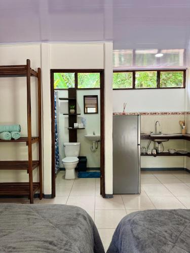 a bedroom with a bathroom with a toilet and a sink at Cabinas Caribe Azul in Cocles