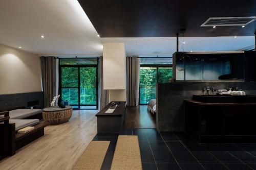a large bathroom with a sink and a living room at 青城山坐忘森林疗愈酒店 in Dujiangyan