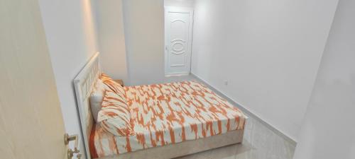 a small bedroom with a bed and a closet at holiday apartment 3 in Jijel