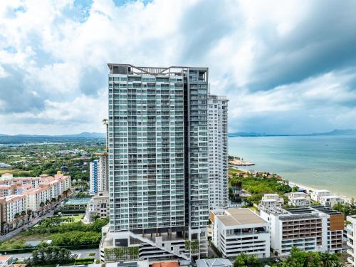 a tall building in front of the ocean at VERANDA PATTAYA - Residence in Jomtien Beach
