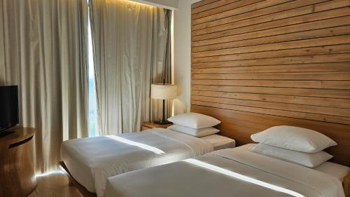 a hotel room with two beds and a window at Villa seaview and apartment -Spa Da Nang Resort by JT group "Free pick up" in Da Nang