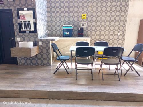 a group of chairs around a table in a kitchen at Casa Bella Estancias in Comalcalco