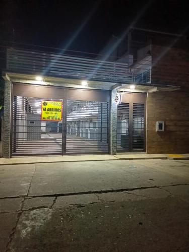 a building with a garage door with a sign on it at Casa Bella Estancias in Comalcalco