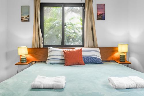 a bedroom with a large bed with two lamps at Casa Ola - Tropical Beachside Escape in Playa Venao
