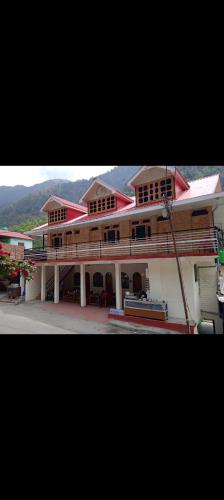 a large building with a bench in front of it at Hotel Ganga view & restaurant in Gangnāni