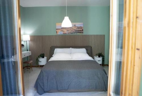 a bedroom with a large bed with white pillows at ApartHotel Verona Centro - Teatro Filarmonico in Verona