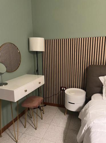 a bedroom with a bed and a desk and a toilet at ApartHotel Verona Centro - Teatro Filarmonico in Verona