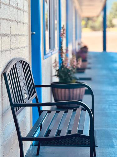 a bench sitting on the side of a building at Relax Inn At Ashland in Ashland