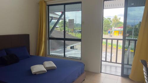 Postel nebo postele na pokoji v ubytování Nucifera Hotel Tambunan